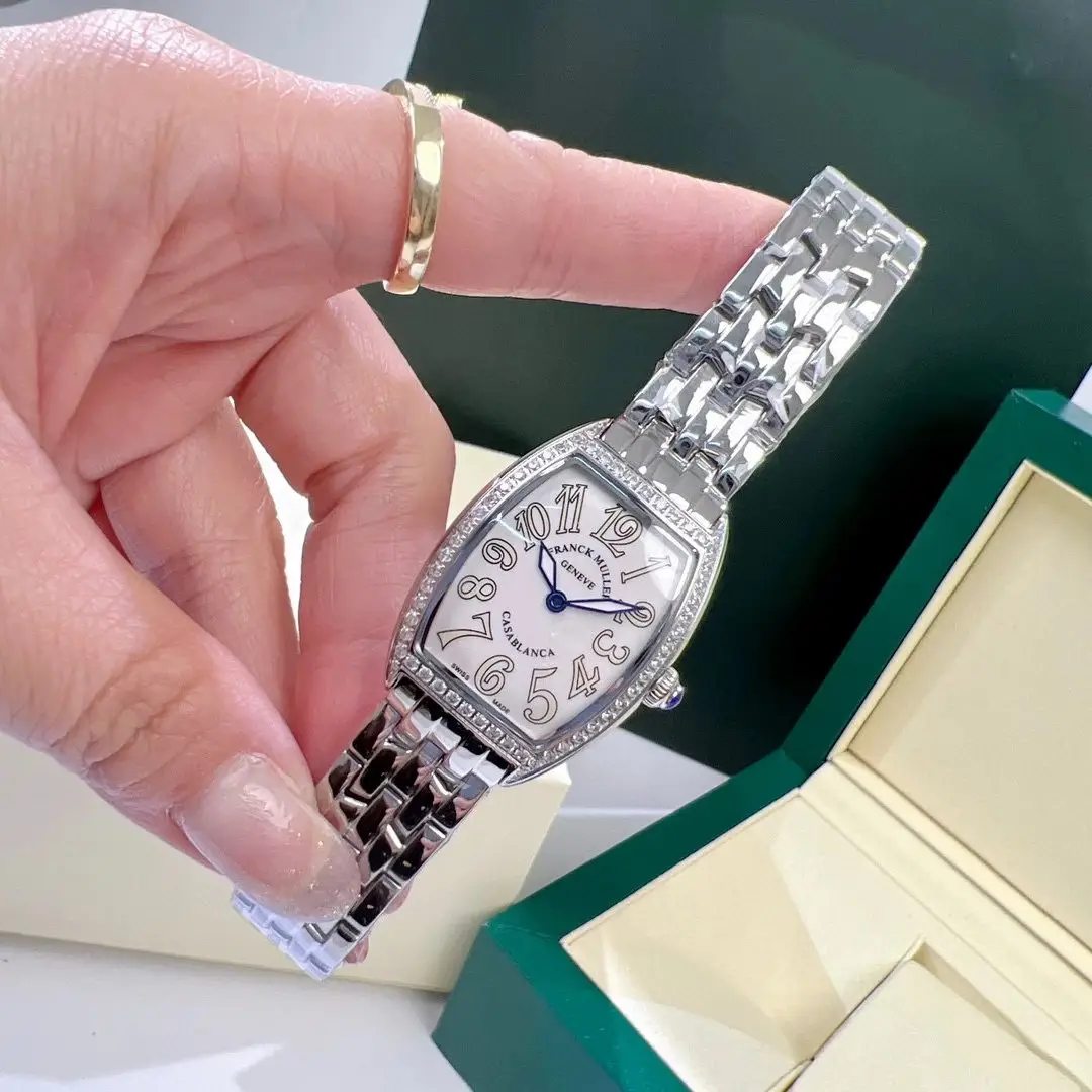 Polished case and dial close-up of barrel watch