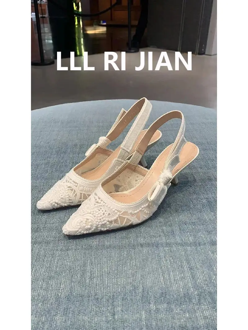 Elegant white stiletto heels pair display